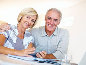 Smiling couple reviewing estate documents. Link to Tangible Personal Property